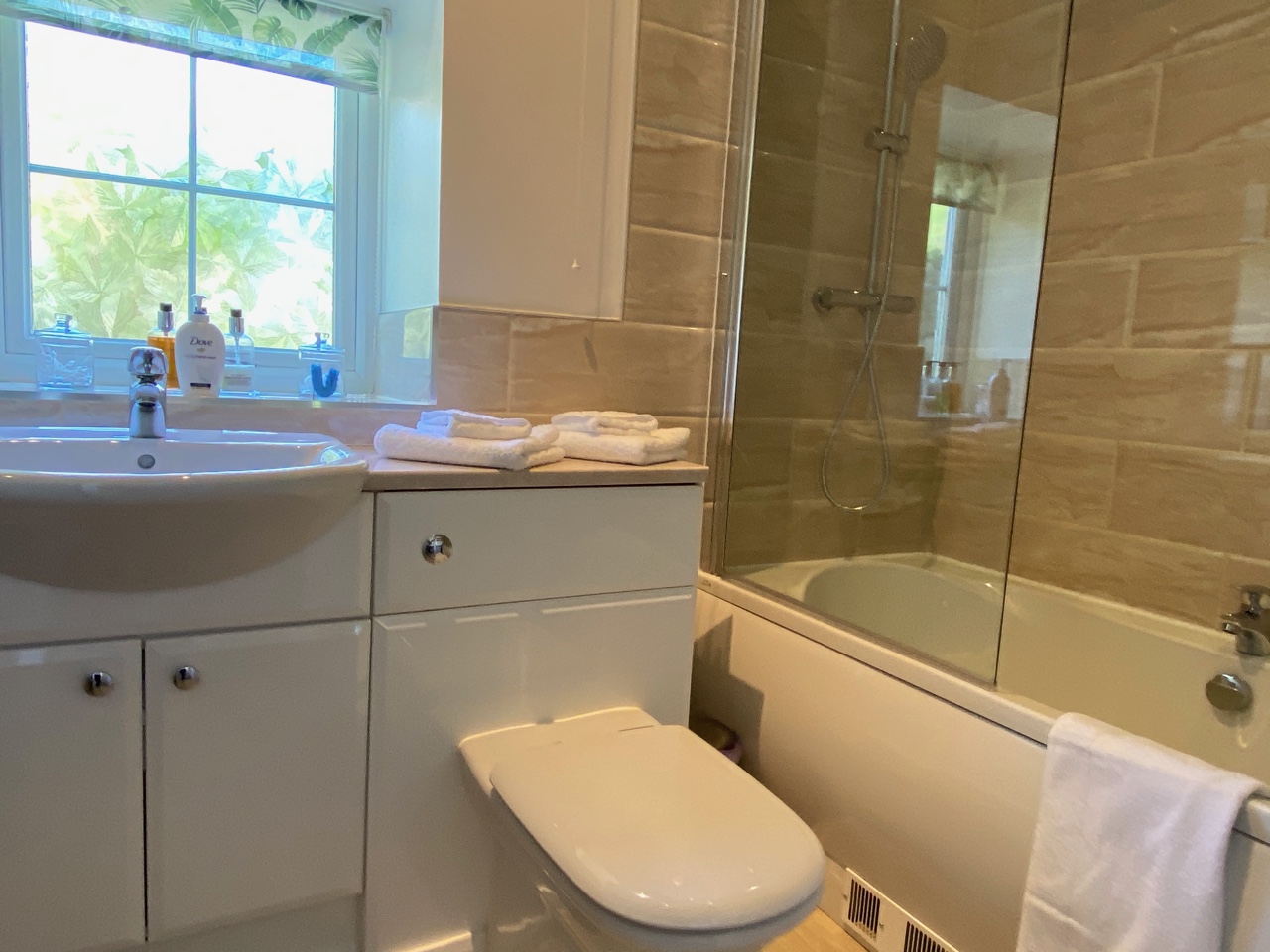 Bathroom - bath with overhead shower, luxury toiletries and towels 5* self catering cottage near Bangor, North Wales